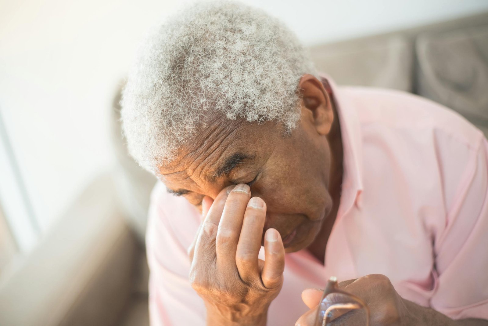 An elderly man with gray hair appears thoughtful in an indoor setting, adding to the contemplative mood.