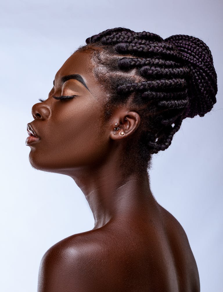 Close-up profile portrait of a woman with braided hair.
