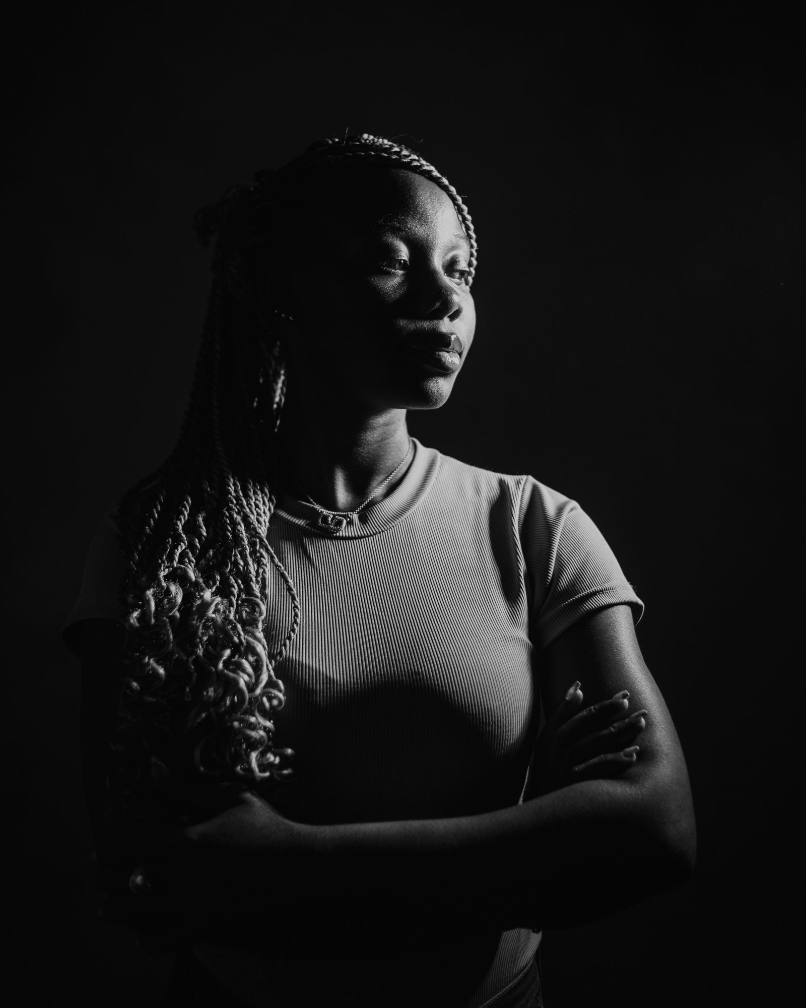 Striking black and white portrait with dramatic lighting and shadows.